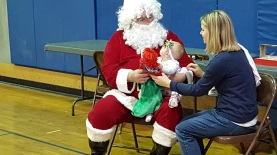 "Santa, you're kinda scary, but you gave me a dolly, so I don't know what to think now."
